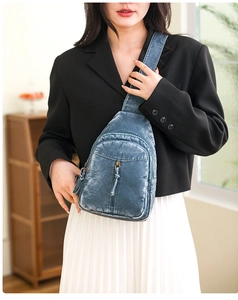 Detailed view of blue retro washed leather chest bag showing zipper compartments and strap