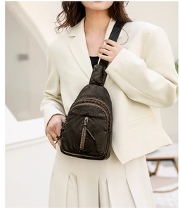 Detail of dark brown vintage PU leather chest bag featuring multiple zipper pockets