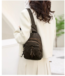 Detailed view of a dark brown vintage PU leather crossbody bag worn by a model