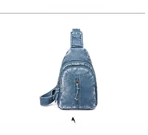 Front view of a navy blue washed leather crossbody bag with dual zipper compartments