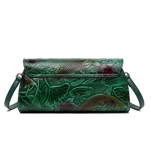 Dark green leather crossbody bag featuring embossed koi fish and lotus floral patterns
