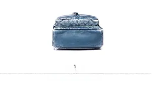Detail view of the rectangular bottom of the dark blue PU leather crossbody chest bag