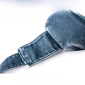 Detail shot of the tight stitching and vintage washed leather texture on blue chest bag