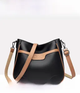 Close-up of black lychee grain texture with brown leather trim and kangaroo logo detail