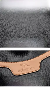 Macro shot of black lychee grain leather texture and embossed light brown kangaroo logo