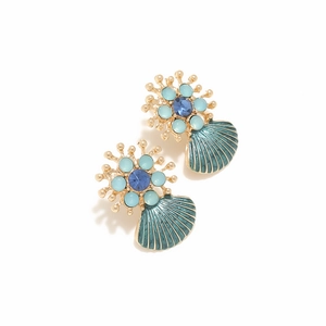 Detailed macro of gold shell earrings with blue rhinestones and teal enamel accents