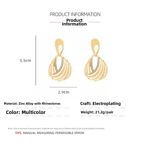 Detail view of gold hollow teardrop earrings with dimensions 5.5cm by 2.9cm and rhinestones