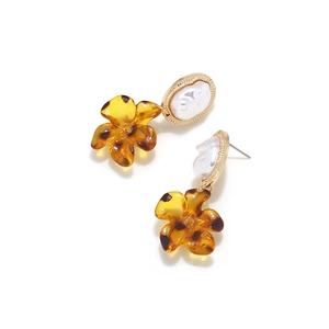 Baroque faux pearl earrings with amber leopard print flower pendant on white background