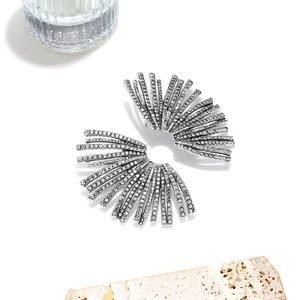 Detailed shot of vintage silver fan-shaped leaf earrings with sparkling rhinestones