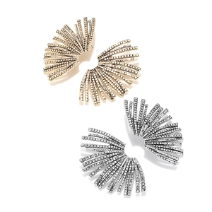Detailed view of gold and silver fan-shaped leaf earrings with sparkling white crystals