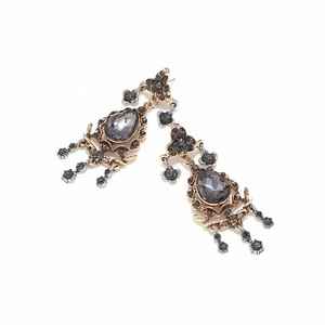 Close-up of vintage hollow alloy earrings with grey crystals and floral tassel details