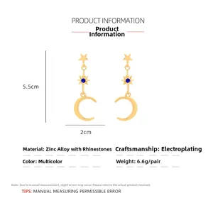Detail view of gold moon and star earrings with blue rhinestones and dimensions
