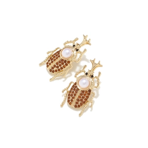 Vintage beetle drop earrings with amber crystals and pearl accents in gold plating