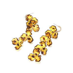 Close-up of leopard print flower pendants on multilayer long drop tassel earrings