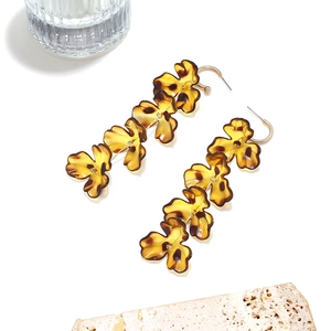 Macro view of leopard print flower petals with golden J-shaped hooks long tassel earrings