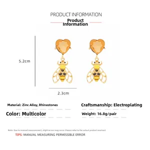 Detailed view of bee heart earrings with size markers 5.2cm height and 2.3cm width