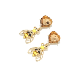 Detail of bee earrings with amber heart gems and colorful enamel patterns