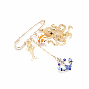 Golden anchor and octopus ocean theme brooch with blue rhinestones on white backdrop