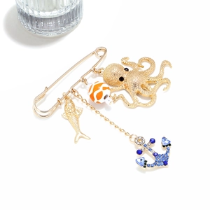 Detail of nautical safety pin brooch with octopus, colorful bead, fish, and anchor charms