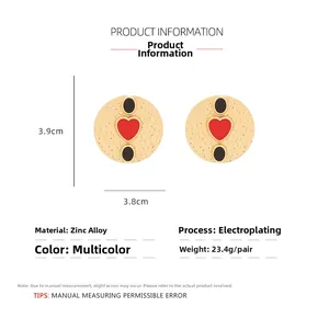 Detailed view of gold textured earrings with red heart and zinc alloy size dimensions