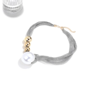 Detail of silver mesh necklace with large white pearl and gold beads with clasp