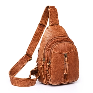 Brown vintage PU leather sling bag with multiple zippers and wide adjustable strap