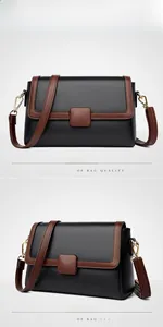 Detail of contrast flap crossbody bag with black lychee leather and brown trim accents
