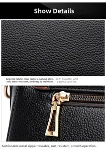 Detail view of black pebble leather texture and shiny gold-tone zipper hardware on the bag