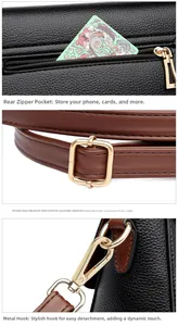Detailed view of black pebbled leather crossbody bag with brown strap and gold hardware