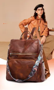 Brown vintage PU leather backpack with bohemian print strap and multi-pocket detail