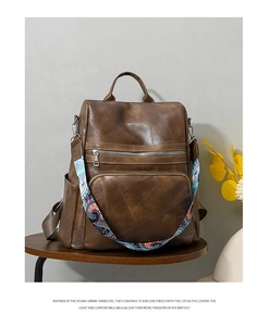 Detail of dark brown leather backpack with bohemian strap and geometric stitching