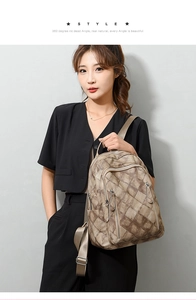 Close-up of brown quilted PU leather backpack with side pockets and smooth zipper details