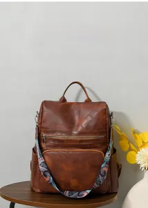 Close-up of brown PU leather backpack texture with bohemian style colorful shoulder strap