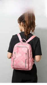 Detailed view of pink plaid quilted soft PU leather backpack on female model