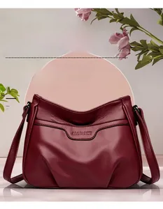 Macro shot of dark red textured leather shoulder bag featuring Allfancy embossed logo