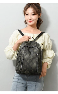 Close-up of retro dark green PU leather backpack with textured checkered embossed pattern