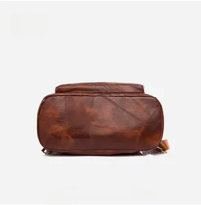 Detailed bottom view of the brown vintage PU leather backpack with sturdy stitching