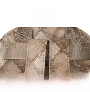 Macro shot of precise stitching and quilted rhombus texture on brown PU leather backpack