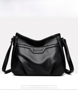 Close-up of black lychee grain faux leather handbag with embossed silver logo detail