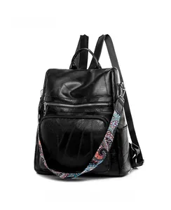 Detail of black faux leather backpack with textured finish and ethnic pattern strap