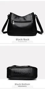 Detail view of black pebble leather crossbody bag showing back pocket and base branding