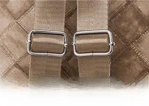 Detail of adjustable nylon straps and silver metal buckles on brown checkered backpack