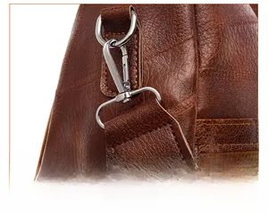 Detail of silver metal buckle and reinforced stitching on dark brown leather backpack