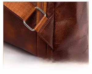 Detail of reinforced stitching and metal buckle on brown PU leather backpack strap