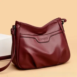 Detailed view of burgundy embossed litchi leather bag with ALLFANCY logo