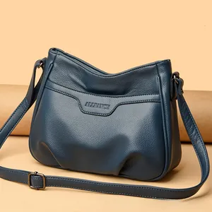 Detail view of navy blue pebbled leather shoulder bag with Allfancy logo and strap