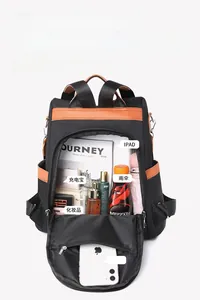 Detail of black nylon backpack interior showing large capacity for iPad, umbrella, and essentials