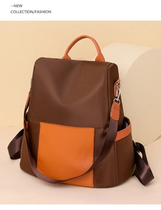 Detail of fashion dual-use backpack with brown nylon and orange leather patchwork