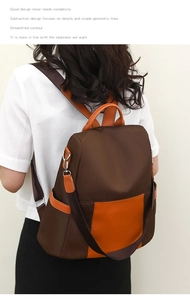 Detail showing high-density nylon fabric and orange leather trim on women's backpack