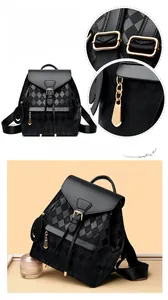 Detail of black diamond quilted backpack featuring gold-tone hardware and smooth leather texture